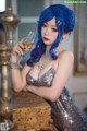 A woman with blue hair holding a glass of wine.