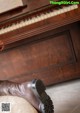 A pair of brown boots sitting on top of a piano.